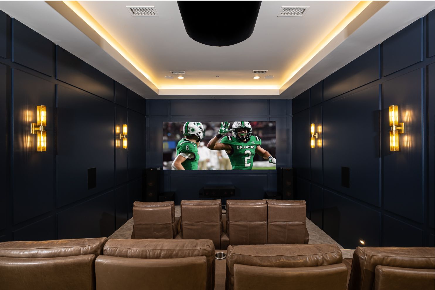 Dedicated home theater with tiered seating and projection screen.jpeg